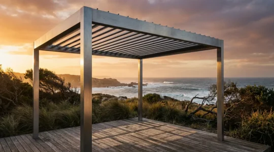 Modern aluminum veranda structure by the ocean at sunset showing durability against coastal elements